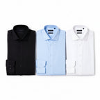 Kit com 3 Camisas Sociais Masculinas Plus Size nas cores preto, branco e azul bebê. Modelagem confortável, manga longa, sem bolso frontal, tecido premium e excelente caimento para trabalho, eventos e uso diário.